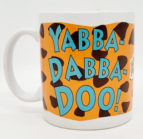 Hanna-Barbera The Flintstones Yabba-Dabba-Doo! Coffee Cup, orange mug featuring blue text and black spots with a cartoon character on the side.