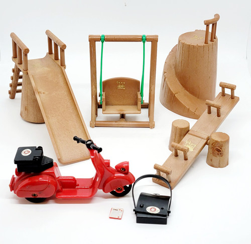 BANDAI Bandai 1986 Maple Town Story Outdoor Playground Set, miniature wooden playground equipment including a slide, swings, and climbing structures, with a red toy scooter and accessories.