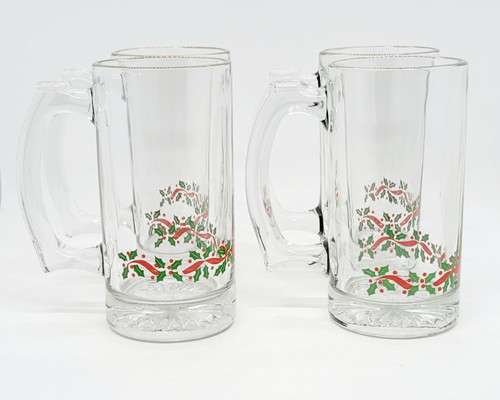 Libbey Glass Company Libbey Christmas Green and Red Holly Beer Mug Set of 4, clear glass beer mugs with festive holly and ribbon design, suitable for holiday celebrations.