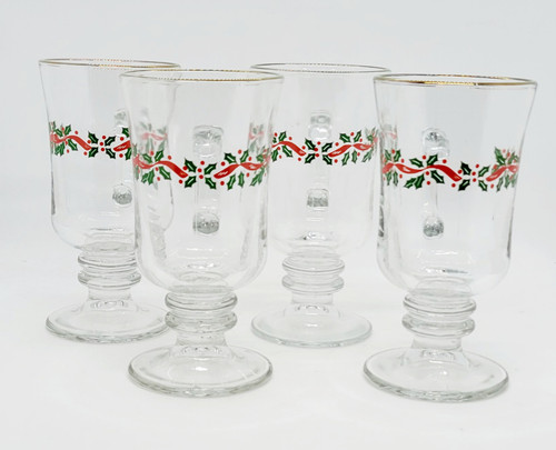 Libbey Glass Company Libbey Christmas Green and Red Holly Irish Coffee Mug Set of 4, transparent glass mugs decorated with Christmas holly and red ribbon design, with gold trim on the rim.
