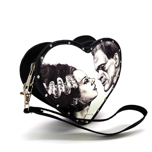 Sleepyville Critters Glow in the Dark Heart Shape Frankenstein w/ Bride Wristlet, black wristlet featuring a heart-shaped design with gothic artwork of Frankenstein and bride, and details like studs and a detachable wrist strap.