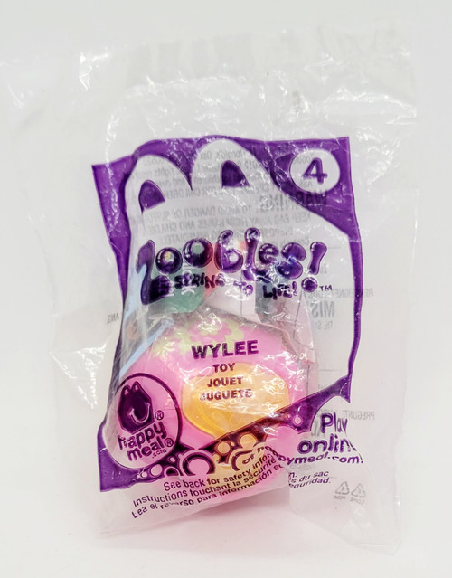 Spin Master McDonald's Happy Meal Toy 2012 Zoobles - #4 Wylee, small pink and yellow capsule-shaped toy inside clear plastic packaging.