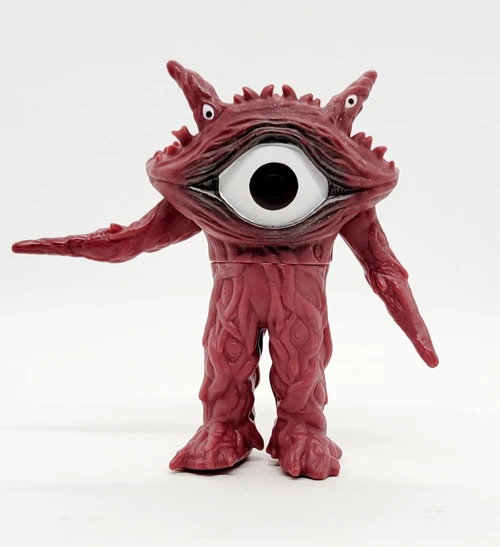 BANDAI Bandai Ultraman Ultra Monster Series #36 Gan-Q Action Figure, a red monster with a large single eye and two smaller eyes on stalks, standing on a white background.