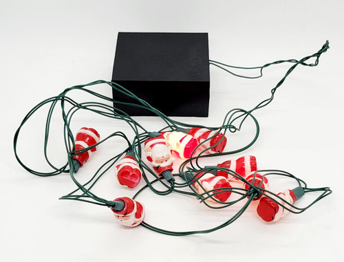 Unknown Battery Operated Blow Mold Plastic 1.25" Santa Claus String Light Set, Christmas-themed string lights with Santa Claus figures and a black power box.