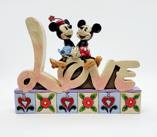 Enesco Disney Traditions Mickey and Minnie Mouse Love Statue, decorative figurine of Mickey and Minnie Mouse sitting on a love-themed base with colorful floral patterns.