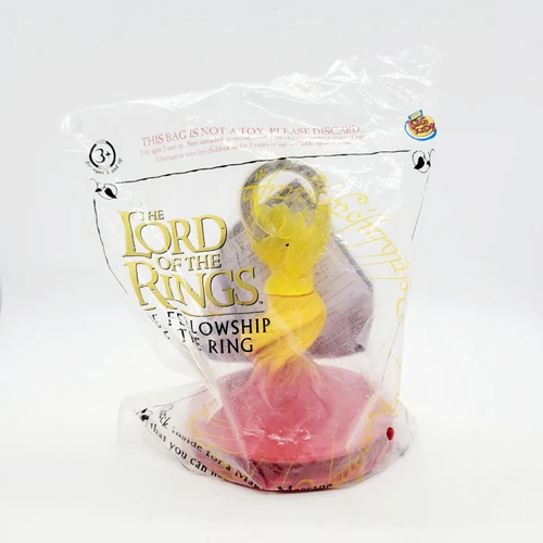 Burger King Big Kids 2001 The Lord of the Rings: The Fellowship of the Ring - The Ring of Power toy in packaging, featuring a yellow ring of power from the movie series.
