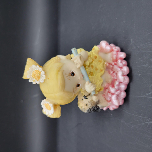Unknown Blonde Hair Girl With Her Puppy Resin Figurine, detailed miniature sculpture of a girl with blonde hair holding a puppy, decorative flowers, and textured base.