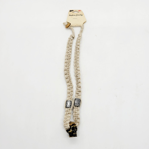 Unknown Braided Necklace With Skull Pendant, cream-colored braided necklace featuring a decorative skull pendant and beads, ideal for fashion jewelry or gothic accessories.