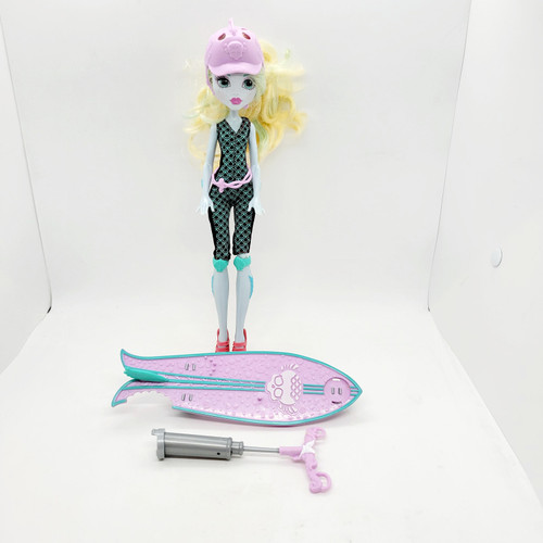 Monster High 2015 Surf to Turf Lagoona Blue Doll, loose doll with surfing accessories including a pink surfboard and a gray toolbox, wearing a black and teal wetsuit and pink sandals, with long blonde hair and a pink cap.