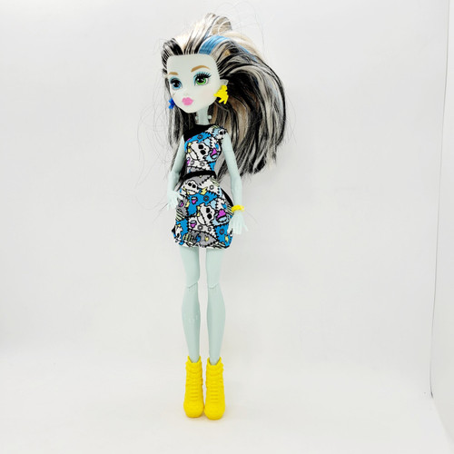 Monster High 2015 How Do You Boo? Frankie Stein Doll, loose doll with black, white, and blue hair, wearing a colorful skull pattern dress and yellow boots.