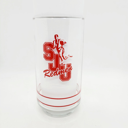 Getty NCAA Big East Basketball Glass Tumbler - Vintage Saint John's University Collectible, clear glass tumbler with red logo featuring a basketball player and the words 'Redmen' on the front.