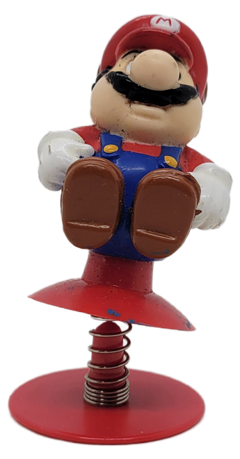 McDonald's Happy Meal Toy of Mario from the 1989 Nintendo Super Mario Brothers 3 series of toys.  Mario has his raccoon tail and is on a spring base.