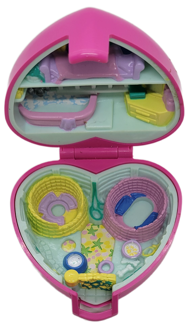 Bluebird 1993 Polly Pocket Precious Puppies pink heart shaped playset 10630.  The playset is 3-inches by 3-inches in size.