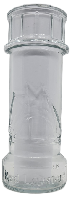 Promotional drinking glass from the Reb Lobster restaurant chain.  The glass is in the shape of a lighthouse with sail boats on it.