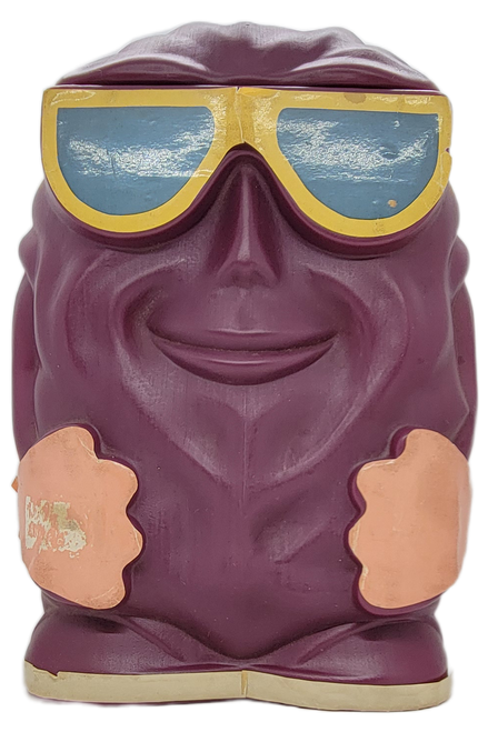 Street Kids 1988 California Raisins piggy bank that is a raisin wearing sunglasses.  The plastic raisin stands 12-inches tall with slot on back to insert money.