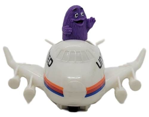McDonald's Happy Meal toy of Grimace in a United Airlines jet from the 1991 Friendly Skies series of toys.  Grimace is in a white United jet that is a pullback toy.  This series of toys were available at airport locations only October 10, 1991 - December 1991.