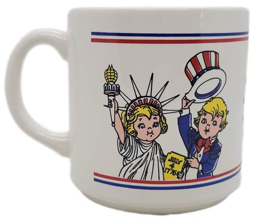 Campbell's Soups salute America ceramic 10oz. coffee mug featuring the Campbell's kids dressed as the Statue of Liberty and Uncle Sam.  The pair are on opposite sides of the mug together with "Campbell's Soups Salute America" in red letters with blue stars circling opposite the handle.