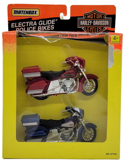 Matchbox 1995 Harley-Davidson Motorcycles Electra Glide Police Bikes Twin Pack, showing two detailed miniature Harley-Davidson Electra Glide police motorcycles in red and blue colors inside a bright yellow packaging box.