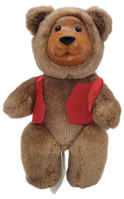 FTD Collector Series 10-inch tall plush bear with wooden face and has jointed neck and legs.  The bear is wearing a red vest and bottom of feet are wooden.