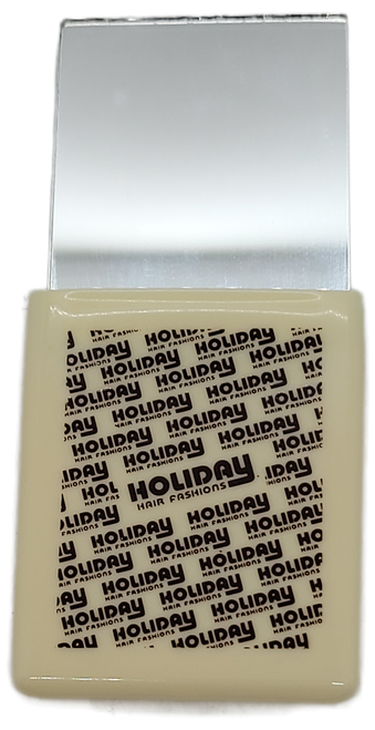 Holiday Hair Fashions promotional pocket mirror in protective rubber case.  The mirror is 3-inches long by 2.25-inches wide and easy to carry in pocket or purse.