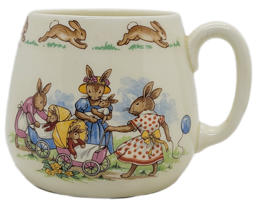 Royal Doulton Bunnykins porcelain mug with a group of anthropomorphic rabbits playing dolls.  The mug is 3-inches tall and made in England.