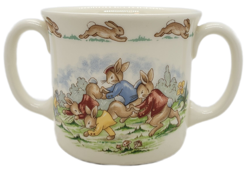 Royal Doulton Bunnykins bone china mug with a group of anthropomorphic rabbits wheelbarrow racing.  The Albion Shape double handled mug is 3-inches tall and made in England.