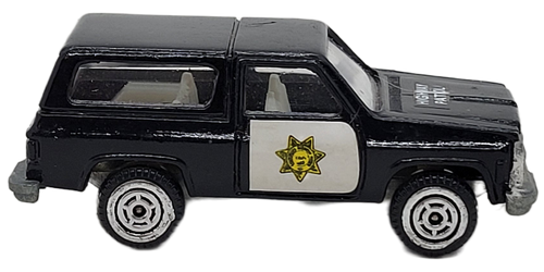 Imperial Toys 1:64 scale die-cast of a Highway Patrol Chevy Blazer from 1980.  The blazer is black with white doors and interior and was made in Hong Kong.