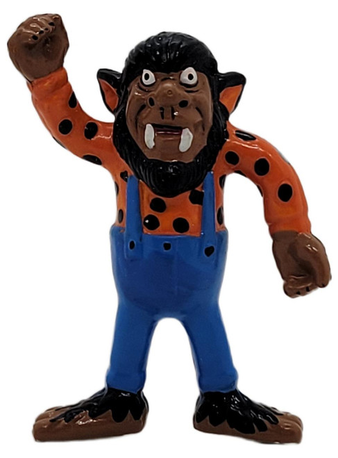 Applause 1989 Wolfman Werewolf 2.5-inch PVC figure, a colorful 1980s collectible depicting a cartoonish, fierce werewolf with black hair, orange spotted shirt, blue overalls, and a raised fist.