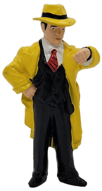 Applause 1990 Disney Dick Tracy (Warren Beatty) 4-inch PVC figure, featuring Dick Tracy in a yellow trench coat and fedora, with a red tie, black vest, white shirt, and black pants, posed with his hand on his hip and the other pointing forward.