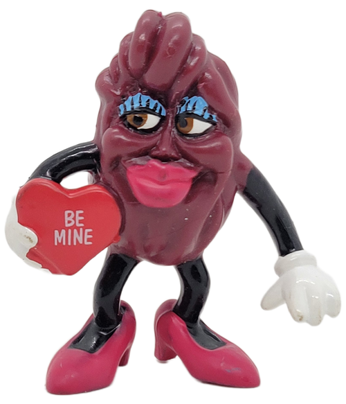 California Raisins Be Mine figure from the 1988 California Raisins Valentines' Day series. Be Mine Raisin with red lipstick and blue eye shadow has left arm at side and right arm holding a heart with "Be Mine" on it.  She also has red shoes with heels on. California Raisins Be Mine figure from the 1988 California Raisins Valentines' Day series. Be Mine Raisin with red lipstick and blue eye shadow has left arm at side and right arm holding a heart with "Be Mine" on it.  She also has red shoes with heels on.