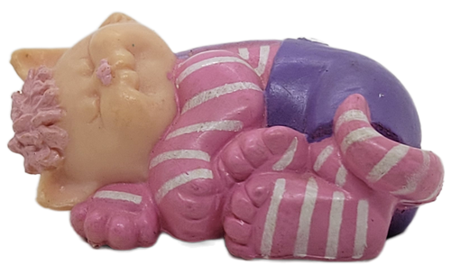 Cabbage Patch Kids 1985 Koosas PVC figure of a cat sleeping named Pep.  This variation of Pep is wearing a pink with white stripes outfit with purple overalls by OAA.  The figure stands 1-inches tall and 2-inches long.
