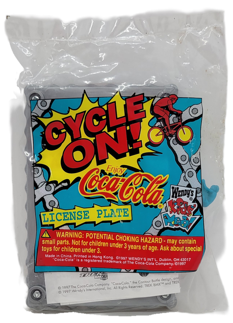 Wendy's Kids' Meal toy of a "Enjoy Coca-Cola" license plate from the 1997 Cycle On! series of toys.  The license plate has a grey plastic band that looks like a chain with red face with a yellow center with "Coca-Cola" in the center and the sun drinking a Coke.  This would be nice for a kids meal collector or Coca-Cola collector.