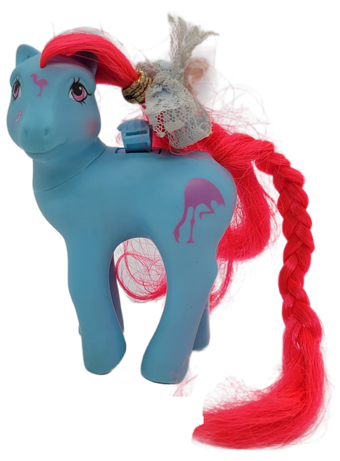 Vintage Hasbro 1987 G1 My Little Pony Flutter Ponies Tropical Breeze. Tropical Breeze is a blue pony with red hair and a flamingo on body. Tropical Breeze is 4-inches tall by 2.5-inches long by 1.5-inches wide and was made in China.