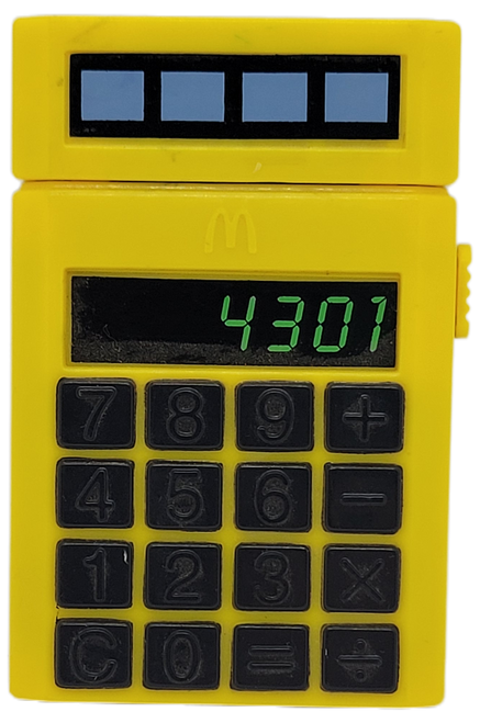 McDonald's Happy Meal toy spy stamper pad calculator from the 1993 M-Squad series of spy toys.  The calculator is yellow and black with 4 different stampers to help Grimace find his runaway voice.  The series contained 4 spy toys and were available January 8 - February 4, 1993.