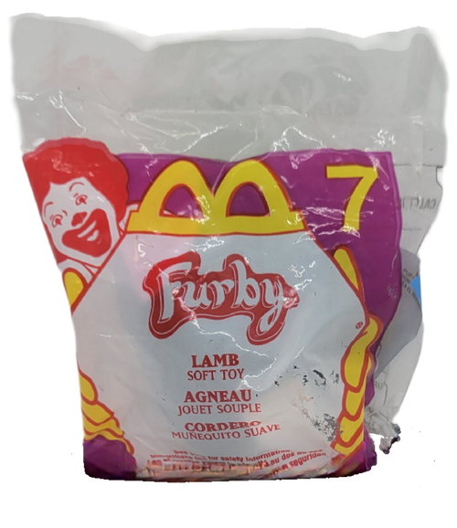 McDonald's Happy Meal Toy of Lamb from the 2000 Furby series of toys. The 2000 series of Furby are plush clip-on figures that stand 3-inches tall. Lamb is black with pink hair and stomach. The series contains 12 different clippable toys and were available March 24 - April 13, 2000.