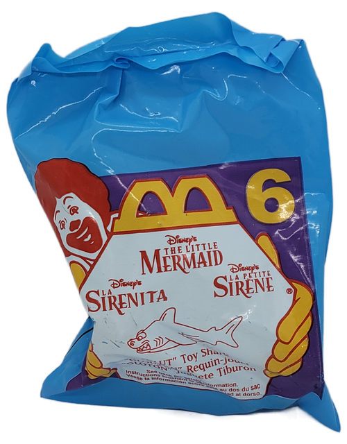 McDonald's Happy Meal toy #6 Glut the Shark from the 1997 Disney's The Little Mermaid Series. Glut's mouth opens and closes as you push him a long. The series contain 8 different character toys and was available November 28 - December 25, 1997.