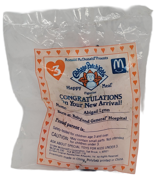 McDonald's Happy Meal toy of Cabbage Patch Kids Abigail Lynn from the 1994 Cabbage Patch Kids/Tonka series of toys. Abigail is 4-inches tall with pink toy soldier outfit and holding candy cane. The series contained 4 different Cabbage Patch Kids and 4 different Tonka trucks and was available December 2 - 29, 1994.