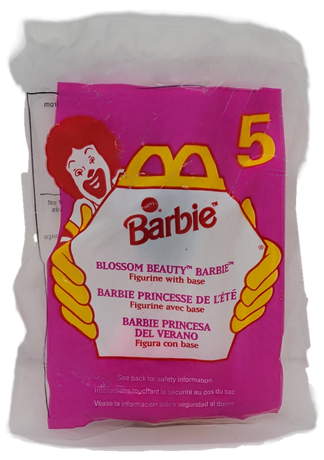 McDonald's Happy Meal toy of Blossom Beauty Barbie from the 1997 Barbie/Hot Wheels series of toys. The Barbie is African-American with pink and purple dress and was available with 4 other Barbies and 5 different Hot Wheels. The series was available October 24 - November 27, 1997.