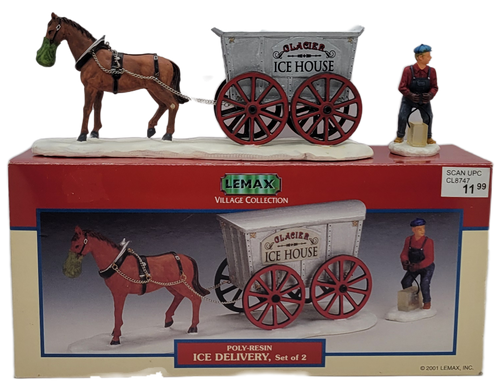 Lemax 2001 Ice Delivery set of 2 from the Village Collection. The set #13366 features a brown horse pulling a silver wagon with Glacier Ice House on the sides of the wagon. The set also includes The ice delivery man wearing blue overalls and red shirt.