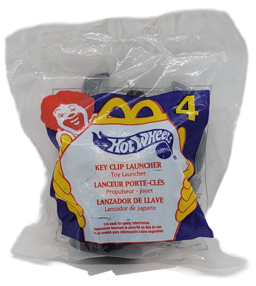 McDonald's Happy Meal toy of a Mattel Hot Wheels Key Clip Launcher from the 2000 "More Fun Than Ever" Barbie/Hot Wheels series of toys. The Key Clip Launcher is grey and is one of the 16 Hot Wheels themed toys in the series that also contains 16 different Barbie themed toys. The series was available September 15 - October 12, 2000.