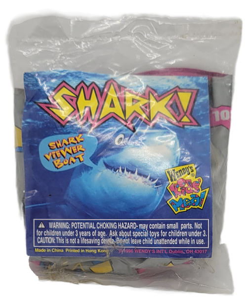 Wendy's Kids Meal toy of a shark viewer boat from the 1996 Shark! series of toys. The inflatable shark viewer boat is silver with pink, yellow and blue symbols all over. The series contains 6 different toys and was available June 17 – July 28, 1996.
