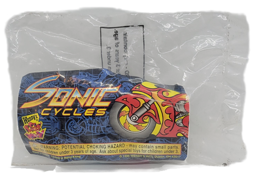 Wendy's Kids' Meal toy of a silver rocket motorcycle from the 1997 Sonic Cycles series of toys. The Sonic Cycle is silver with a rocket rear with purple seat and blue shield. The series contains 5 different Sonic Cycles and was available March 24 – May 4, 1997.