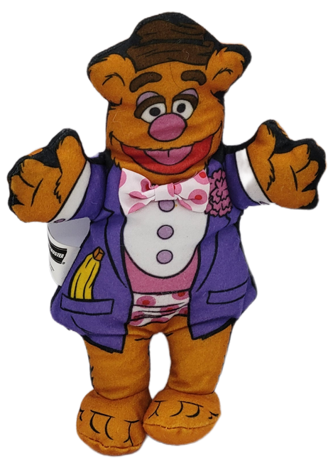 Blockbuster Video promotional plush of Fozzie Bear from the 1998 "Muppet Stars Dressed For Opening Night" series of plush. Fozzie Bear is 7-inches tall and is wearing a purple jacket with pink polka dot bowtie.
