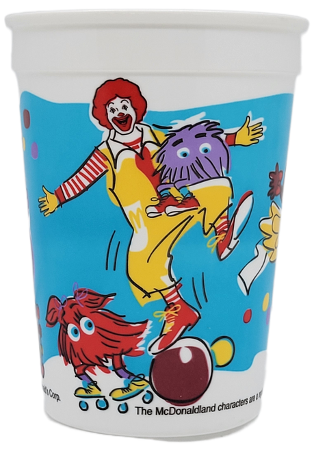 McDonald's 1996 plastic cup featuring McDonaldland characters, Ronald McDonald, Grimace, Fry Guys and Birdie the Early Bird. Ronald McDonald is standing on a brown ball with purple Fry Guy is sitting on his knee. Red Fry Girl is roller skating behind Grimace that is wearing yellow and red roller skates and hat. Birdie the Early Bird is kicking a red, yellow and green beach ball.