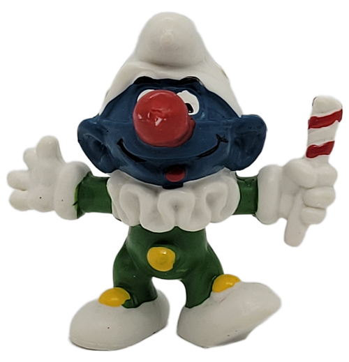 20090 Jester Smurf is here to entertain you! The Jester Smurf wears a green clown outfit, a big red nose and holds a red and white stick for ages 3 & up. This funny Smurf even has gold stars on his hat! 20090 Jester Smurf PVC Figure From 1976.
