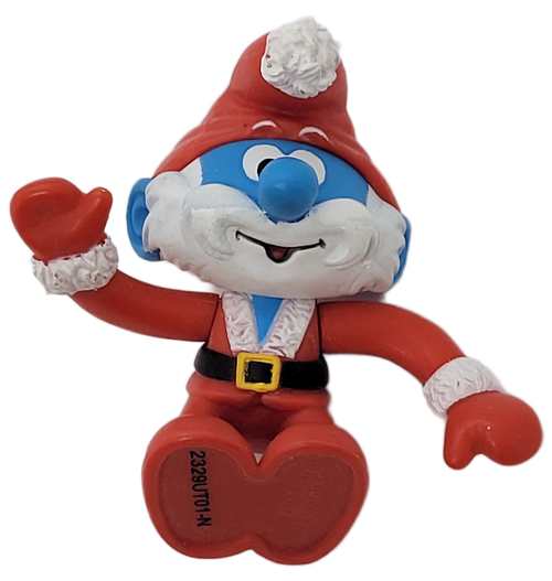 Jakks Pacific 2009 Santa Papa Smurf figure in sitting position from The Smurfs Holiday Gift Pack. Santa Papa Smurf is wearing a red Santa suit with red shoes and stands 2-inches tall. The set is recommended for ages 4 & up and was made in China.