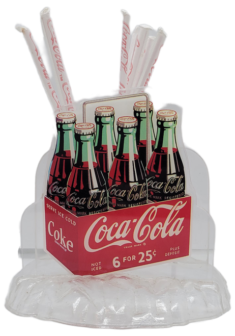 Coca-Cola 1995 napkin and straw holder made of plastic. The front has a picture of a 6-pack of bottled Coca-Cola. The base is cleared resembles ice. The holder was made in Hong Kong.

Coca-Cola
1995 Napkin and Straw holder
Features 6-pack of Bottles of Coke
7" Wide x 6" Deep x 6.5" Tall
Made in Hong Kong