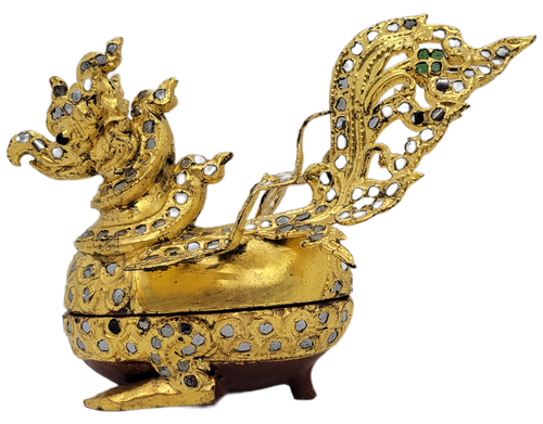 Burmese Hintha Bird Shaped Betel Box that originates from Mandalay, Myanmar (Burma). They are shaped like the Hintha bird (or Hamsa), a sacred goose associated with royalty and prosperity. They are crafted from lacquered wood and metal, then tiled and embellished with high-relief decoration known as thayo. The surface is encrusted with color glass or gemstones and pieces of mirror to create a shimmering effect. They were used to hold eel nut for offerings in Buddhist monasteries or during ceremonies.