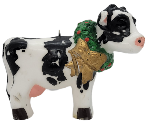 Novelty Christmas candle of a Holstein cow wearing a wreath around neck. The cow is standing and looking to her side. The single wick candle is by Boston Warehouse Trading Corp and was made in China.