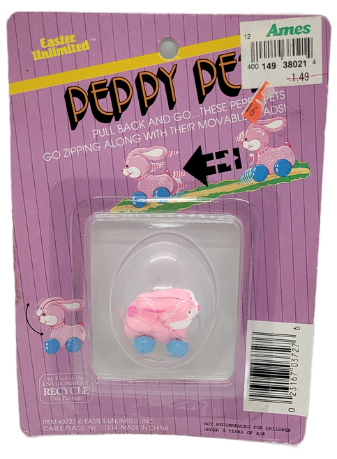 Small pink bunny pull back toy by Easter Unlimited. The bunny is pink with blue wheels. The bunny is 1.5-inches long and stands 1.5-inches tall and for ages 3 & Up.
